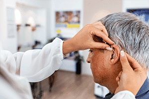 Man getting hearing aids fitted